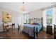 Relaxing bedroom with a wrought iron bed, chandelier, and ample natural light at 94 Two Creeks, Chapel Hill, NC 27517