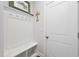 Mudroom with bench seating and storage beneath wall hooks for hanging coats and personal items at 94 Two Creeks, Chapel Hill, NC 27517