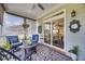 Cozy covered porch with comfortable blue chairs, decorative rug, and a peaceful outdoor view at 94 Two Creeks, Chapel Hill, NC 27517