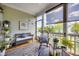 Relaxing screened porch with comfortable seating, decorative rug, and a serene outdoor view at 94 Two Creeks, Chapel Hill, NC 27517