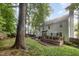 The house has a lush backyard, mature trees, and a charming wood deck at 9408 Bells Valley Dr, Raleigh, NC 27617