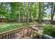 View of the lovely fenced backyard with mature trees and landscaping, seen from the deck at 9408 Bells Valley Dr, Raleigh, NC 27617