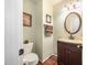 Cozy bathroom featuring a dark vanity, granite countertop, and a toilet at 9408 Bells Valley Dr, Raleigh, NC 27617