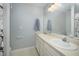 Bright bathroom with a large mirror, double sinks, and neutral walls at 9408 Bells Valley Dr, Raleigh, NC 27617