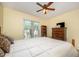Bedroom featuring a ceiling fan, neutral carpeting, and a wooden dresser at 9408 Bells Valley Dr, Raleigh, NC 27617