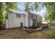 Back of the home featuring a wood deck with a table and umbrella, as well as a green door at 9408 Bells Valley Dr, Raleigh, NC 27617