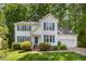 Charming two-story home with a well-manicured lawn and traditional architectural details and a 2 car garage at 9408 Bells Valley Dr, Raleigh, NC 27617