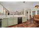 Functional kitchen showcasing green cabinets, modern appliances, and seamless flow to the dining area at 9408 Bells Valley Dr, Raleigh, NC 27617