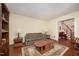 Comfortable living room with a couch, wooden furniture, and hardwood flooring at 9408 Bells Valley Dr, Raleigh, NC 27617