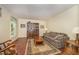 Cozy living room with hardwood floors, classic furnishings, and natural light streaming through the windows at 9408 Bells Valley Dr, Raleigh, NC 27617