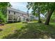 Expansive backyard with covered porch, patio seating, and well-manicured lawn at 9517 Candor Oaks Dr, Raleigh, NC 27615