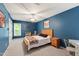 Well-lit bedroom features a fan, window, and a bed with side tables at 9517 Candor Oaks Dr, Raleigh, NC 27615