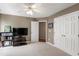 Bedroom with carpeting, white ceiling fan, and storage closet at 9517 Candor Oaks Dr, Raleigh, NC 27615