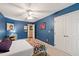 Cozy bedroom with blue walls, white trim, and a comfortable bed with a colorful quilt at 9517 Candor Oaks Dr, Raleigh, NC 27615