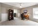 Bonus room features neutral paint, carpeting, desk area, and bookcase at 9517 Candor Oaks Dr, Raleigh, NC 27615