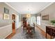 Formal dining room with hardwood floors, elegant lighting, and views to the backyard at 9517 Candor Oaks Dr, Raleigh, NC 27615