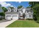 Charming two-story home with an attached two-car garage and a well-maintained front yard at 9517 Candor Oaks Dr, Raleigh, NC 27615