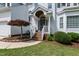 Inviting front entrance with a covered porch, brick steps, and charming landscaping at 9517 Candor Oaks Dr, Raleigh, NC 27615