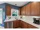Kitchen with wooden cabinets, quartz countertops, stainless steel appliances, and tile backsplash at 9517 Candor Oaks Dr, Raleigh, NC 27615