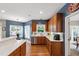 Eat-in kitchen with wooden cabinets, stainless appliances, and hardwood floors at 9517 Candor Oaks Dr, Raleigh, NC 27615