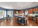Eat-in kitchen with blue walls, wood cabinets, stainless appliances, and hardwood floors at 9517 Candor Oaks Dr, Raleigh, NC 27615