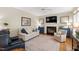 Cozy living room with fireplace, ceiling fan, and hardwood floors at 9517 Candor Oaks Dr, Raleigh, NC 27615