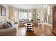 Inviting living room with hardwood floors, a bay window, and a view to the foyer at 9517 Candor Oaks Dr, Raleigh, NC 27615