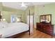 Bright main bedroom featuring hardwood floors, and classic furniture at 9517 Candor Oaks Dr, Raleigh, NC 27615