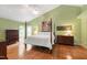 Spacious main bedroom with hardwood floors, vaulted ceiling, and a large window with blinds at 9517 Candor Oaks Dr, Raleigh, NC 27615