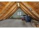 Attic space with wood walls, a small window, and a desk with chairs at 1003 W Divine St, Dunn, NC 28334