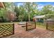Backyard featuring wooden deck with inground spa, a lawn and a black fence at 1003 W Divine St, Dunn, NC 28334