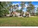 Expansive backyard featuring a well-maintained lawn, mature trees, and a charming home at 1003 W Divine St, Dunn, NC 28334
