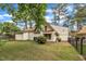 Exterior view of the home showcasing the backyard, complemented by the well-manicured lawn at 1003 W Divine St, Dunn, NC 28334