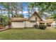 Backyard featuring an in-ground spa, lush lawn, mature trees, and fencing at 1003 W Divine St, Dunn, NC 28334