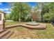 The backyard showcases the deck and inground spa, with lush lawn and black fence at 1003 W Divine St, Dunn, NC 28334