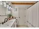 Bright bathroom featuring updated vanity, fixtures, and wood ceiling at 1003 W Divine St, Dunn, NC 28334