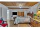 A traditional bedroom with a wooden ceiling, tv, and comfortable interior at 1003 W Divine St, Dunn, NC 28334