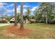 Home exterior with mature trees in the yard, a unique garage, and a well-maintained lawn at 1003 W Divine St, Dunn, NC 28334