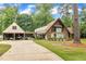 A-frame home featuring a long driveway leading to the attached garage with additional storage at 1003 W Divine St, Dunn, NC 28334