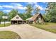 Exterior view of home with a tree-lined yard, long driveway and attached garage at 1003 W Divine St, Dunn, NC 28334