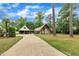 Exterior view of home with a tree-lined yard, long driveway and attached garage at 1003 W Divine St, Dunn, NC 28334