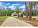 Exterior view of a home with attached garage on a spacious, tree-lined lot at 1003 W Divine St, Dunn, NC 28334