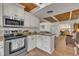 Kitchen featuring white cabinets, stainless appliances, granite counters, and wood ceiling at 1003 W Divine St, Dunn, NC 28334