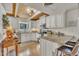 Bright kitchen featuring white cabinets, stainless appliances, and a granite breakfast bar at 1003 W Divine St, Dunn, NC 28334