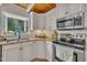 Kitchen features white cabinets, stainless appliances, granite counters, and a window view at 1003 W Divine St, Dunn, NC 28334