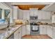 Kitchen featuring white cabinets, stainless appliances, granite counters, and a window view at 1003 W Divine St, Dunn, NC 28334