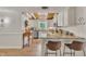 Charming kitchen featuring white cabinets, stainless appliances, and a granite breakfast bar at 1003 W Divine St, Dunn, NC 28334