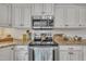 Kitchen featuring white cabinets, stainless appliances and granite counters at 1003 W Divine St, Dunn, NC 28334