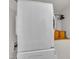 White, stacked washer and dryer inside of a laundry room at 1003 W Divine St, Dunn, NC 28334