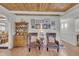 Cozy living room with wood floors, accent chairs, and an adjacent dining area at 1003 W Divine St, Dunn, NC 28334